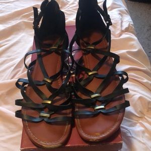 Black sandals with gold accent